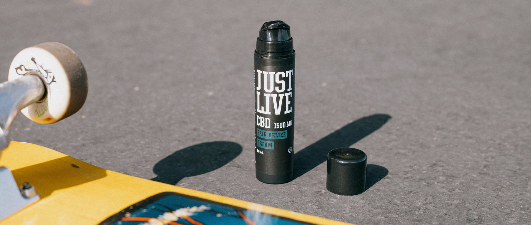 Skateboard Image with Just Live Fast-Acting Pain Relief Cream  